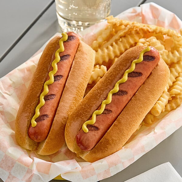 A Hebrew National beef hot dog with mustard in a bun on a paper tray with fries.