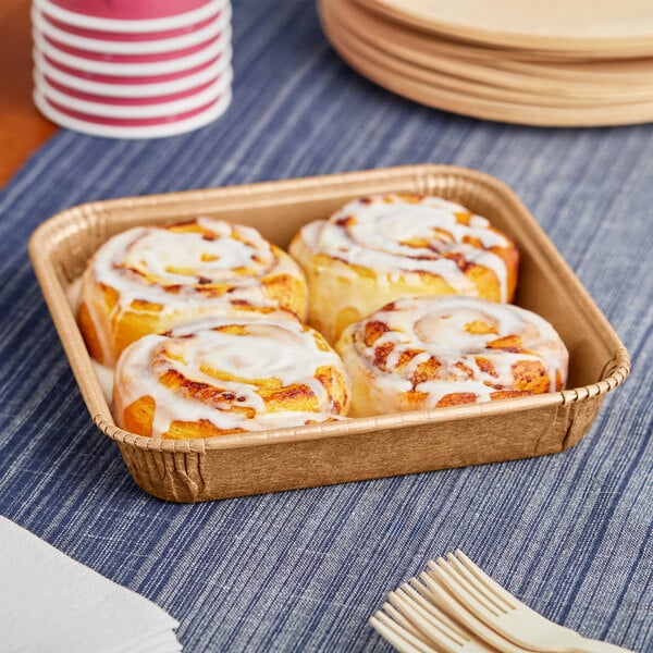 A Solut tray of cinnamon rolls with a fork.