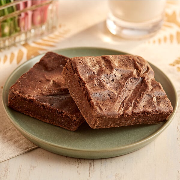 An OMG...It's Gluten Free fudge brownie on a plate next to another brownie.