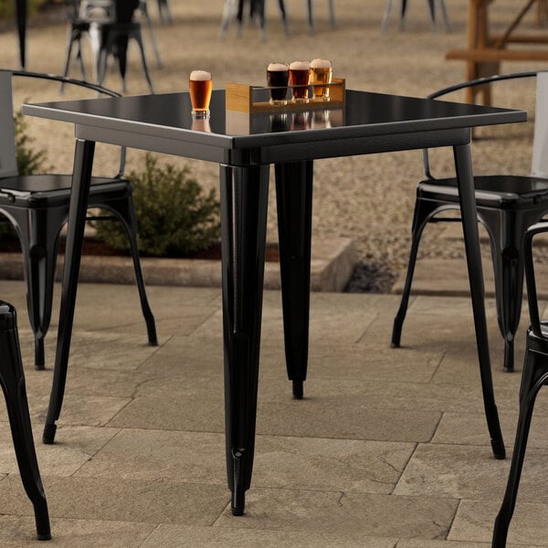 A Lancaster Table & Seating black metal table with black metal legs.
