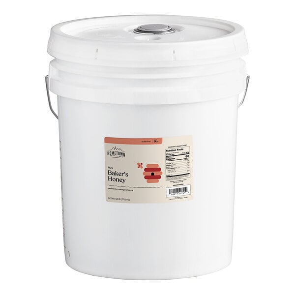 A white bucket with a lid and a label for Hometown Provisions Baker's Special Honey.