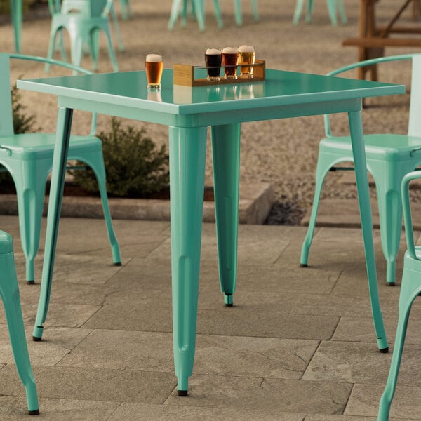 A Lancaster Table & Seating outdoor table and chairs on a patio.