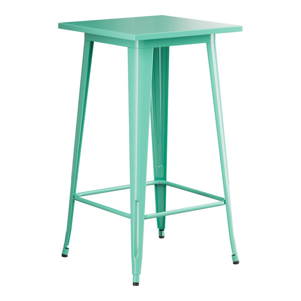 A green metal Lancaster Table & Seating bar height table with a white top.