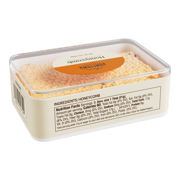 A plastic container of Hometown Provisions honeycomb with an orange label.