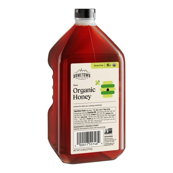 A bottle of Hometown Provisions Organic Wildflower Honey with a label.