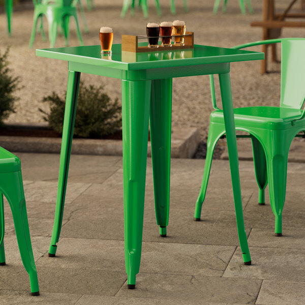 A Lancaster Table & Seating Jade Green table with legs and drinks on it.