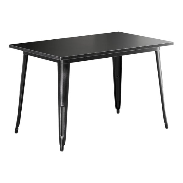 A Lancaster Table & Seating distressed onyx black rectangular table with metal legs.