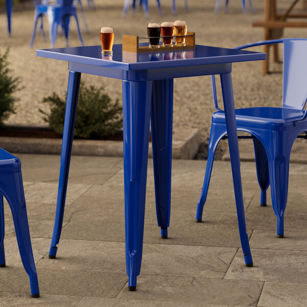 A blue table with legs and glasses on top.