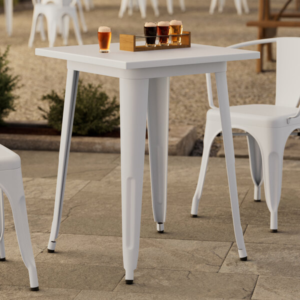 A white table and chairs on a patio.