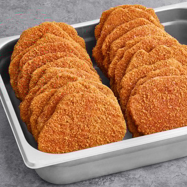 A tray of Rebellyous Spicy Kickin' Chicken Patties on a metal pan.