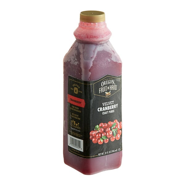 A bottle of Oregon Fruit In Hand Velvet Cranberry Puree filled with red liquid.