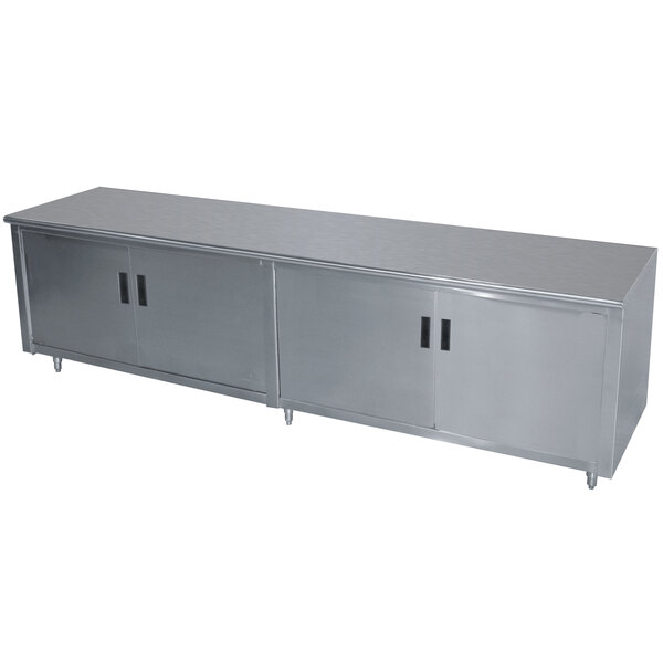 A stainless steel cabinet with two doors on a stainless steel work table.