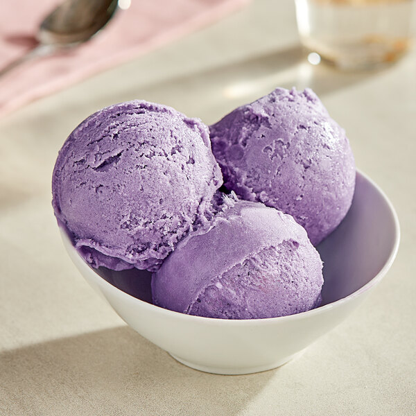 A bowl with three scoops of Acai Roots Ube Sorbet.