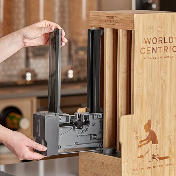 A person opening a box with a World Centric Knife Tower inside.