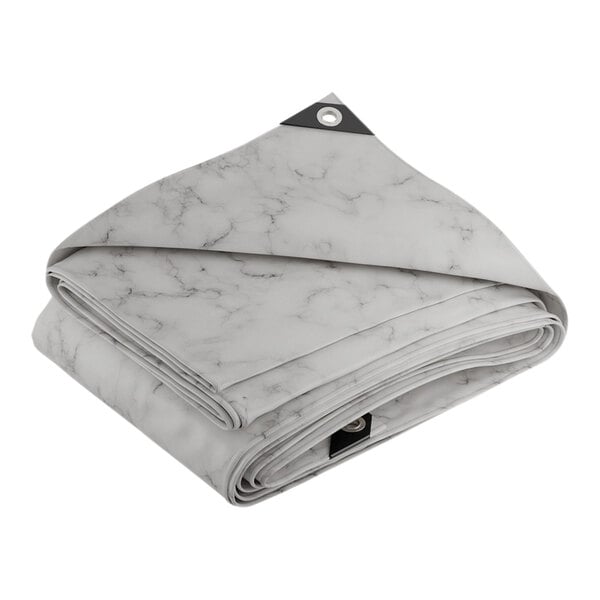 A folded white and grey CORE Extreme Heavy Duty tarp.