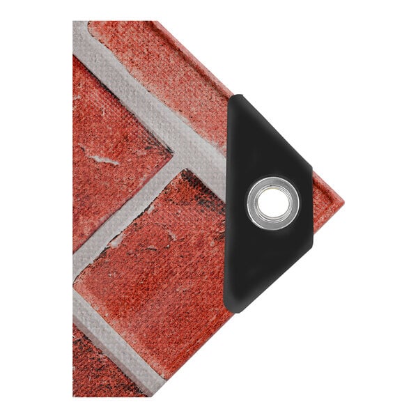 A corner of a black and red brick wall with a CORE Heavy Duty Tarp covering it.