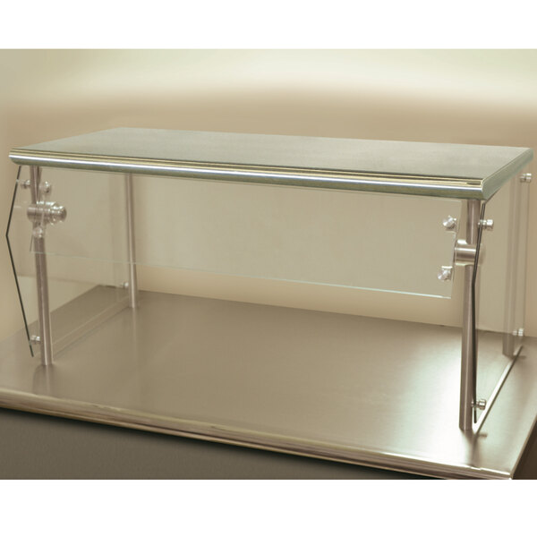 An Advance Tabco single tier self service food shield with metal legs on a counter.
