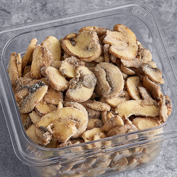 A plastic container filled with Phillips Gourmet Mushrooms IQF Seasoned Sautéed Roasted Sliced White Mushrooms.