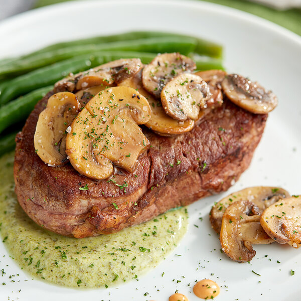 A plate of food with steak, green beans, and Phillips Gourmet Seasoned Sliced White Mushrooms.