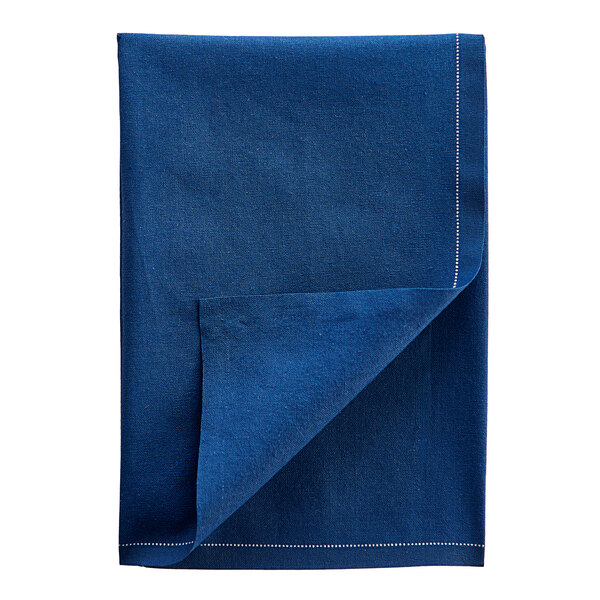 A navy blue cloth napkin folded in a triangle on a white background.