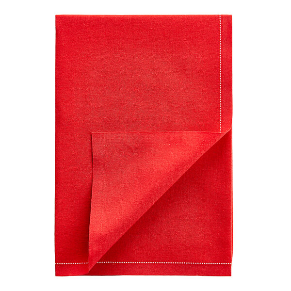 A red cloth napkin folded in half with white stitching.