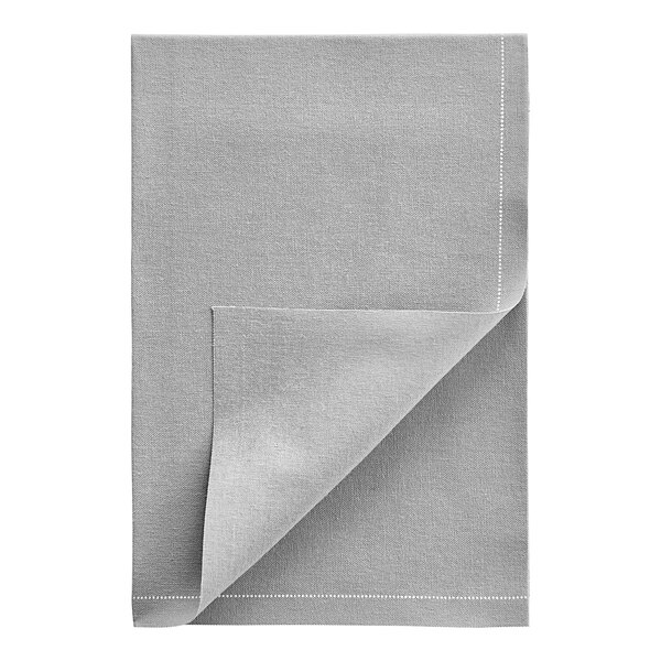 A folded grey cloth napkin with a corner showing.