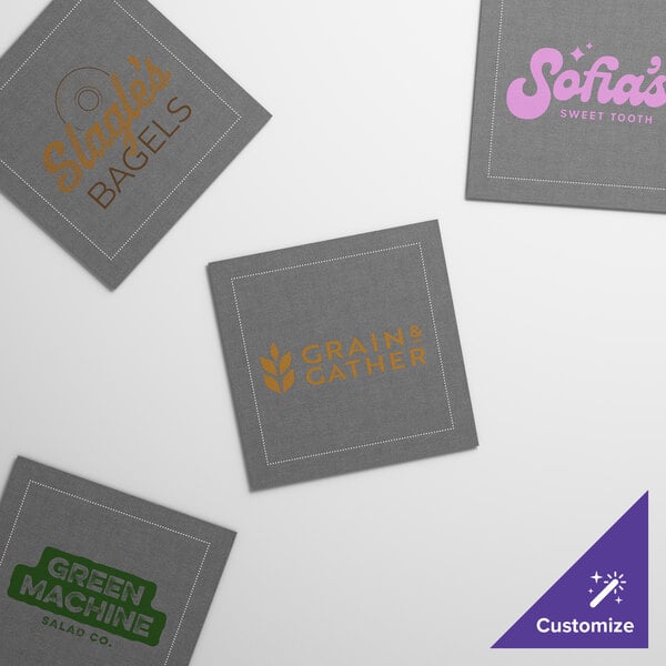 A group of gray square single-use beverage napkins with four different logos on them.