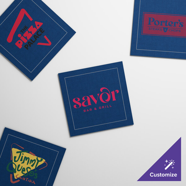 A navy blue square beverage napkin with a yellow triangle and green text.