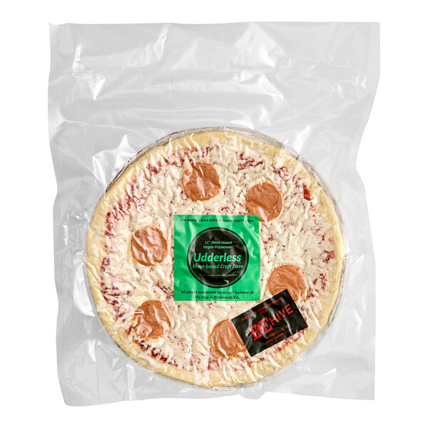 A Udderless Vegan Pepperoni Pizza wrapped in plastic with a green label.