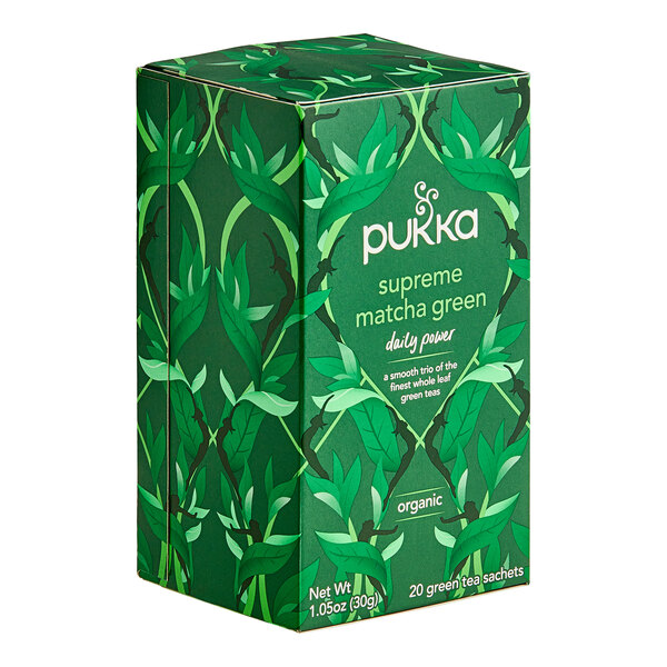 A green box of Pukka Organic Supreme Matcha Green Tea bags with leaves on it.