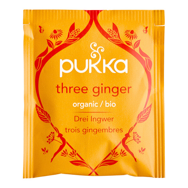 A yellow Pukka Organic Three Ginger Tea packet with red and white text.