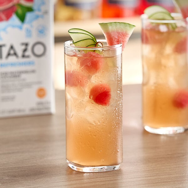 A glass of Tazo watermelon cucumber juice with ice.