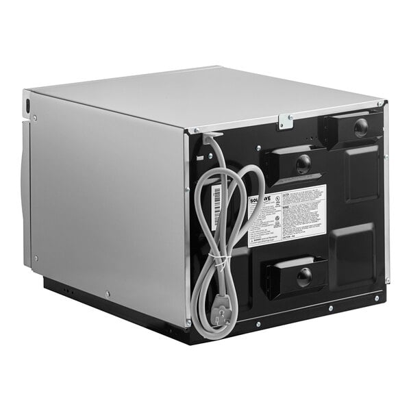 A Solwave stainless steel commercial microwave with a rectangular box of wires.