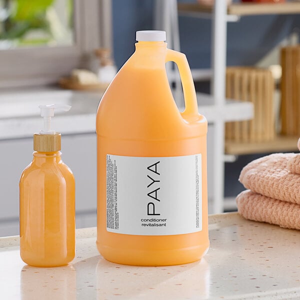 A PAYA Papaya conditioner jug next to a PAYA Papaya lotion bottle.