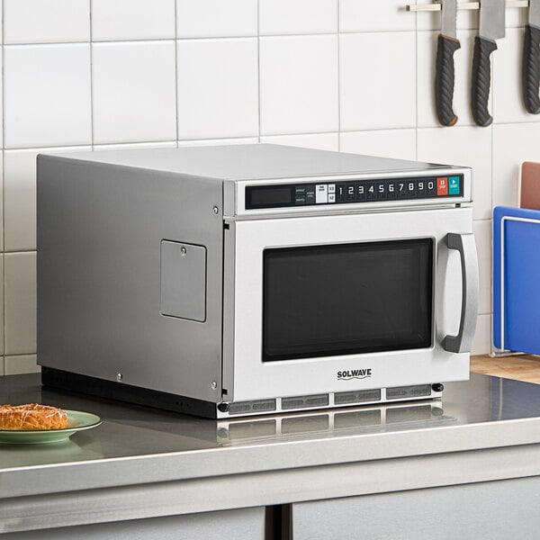 A Solwave stainless steel commercial microwave oven on a counter.