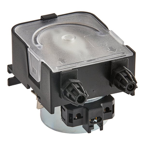 A close up of a black and clear plastic Noble Warewashing detergent dosing pump with a round metal cylinder.