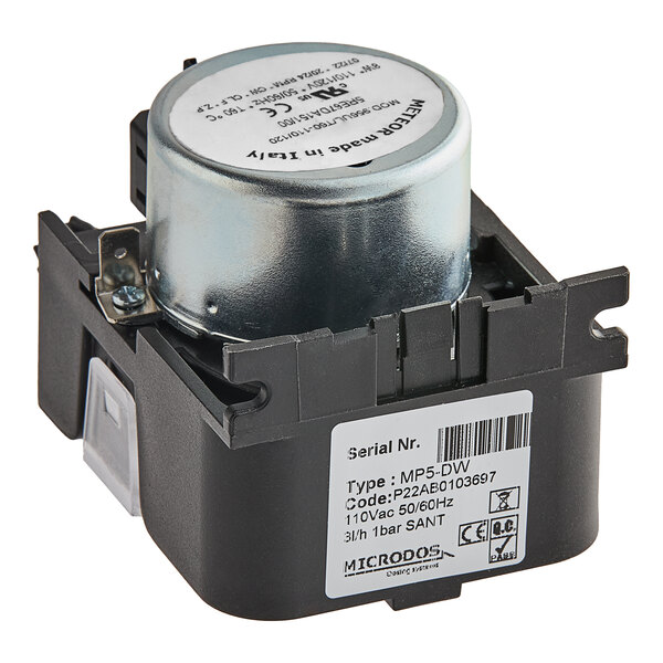 A black and silver Noble Warewashing detergent dosing pump with a white label.