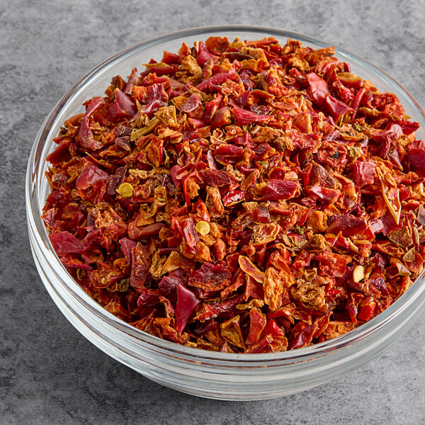 A bowl of red diced bell peppers.