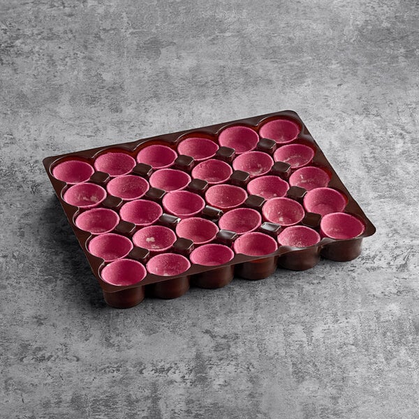 A tray of White Toque pink flared tart shells with pink circles.