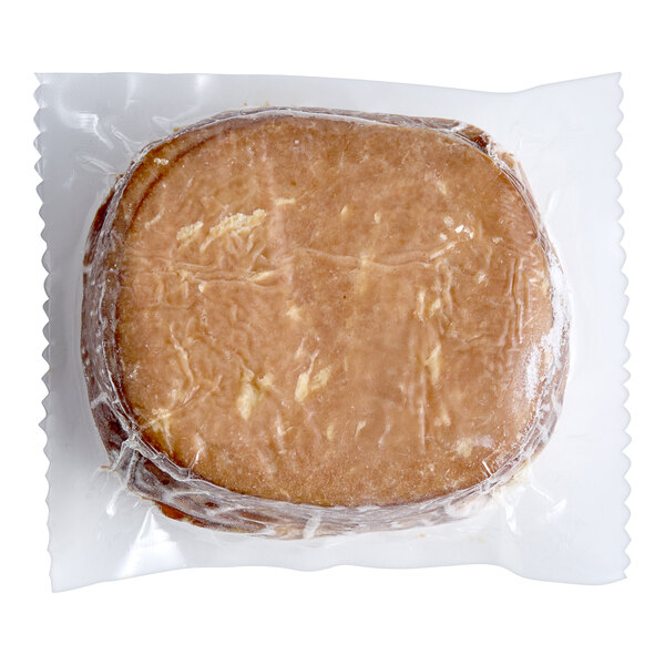 A piece of Tofurky smoked ham deli meat in plastic wrap.