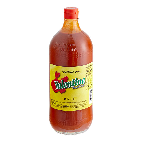 A close up of a bottle of Valentina Red Label Mexican hot sauce.