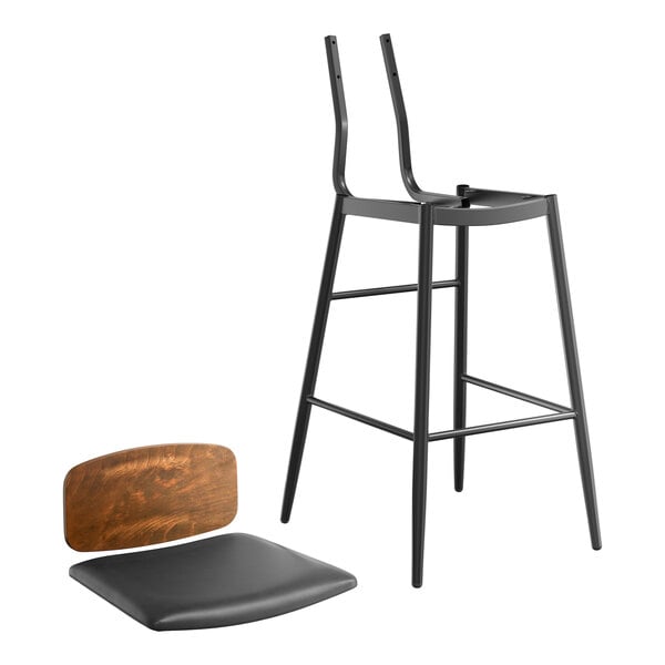 A Lancaster Table & Seating black bar stool with a black vinyl seat and wood backrest.