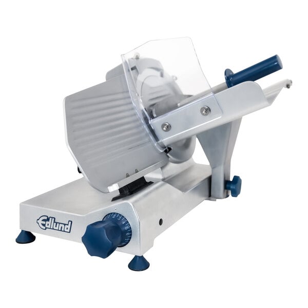 An Edlund light-duty electric meat slicer with a blue and grey machine and a clear cover.