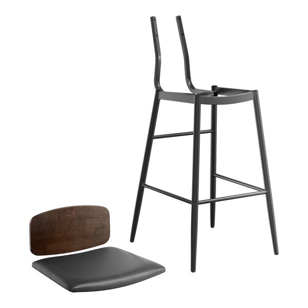 A Lancaster Table & Seating black bar stool with an espresso wood backrest and black vinyl padded seat.