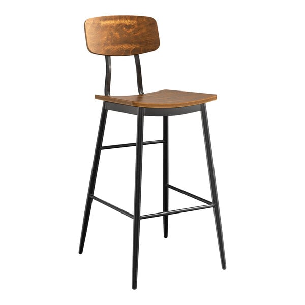 A Lancaster Table & Seating Mid-Century black barstool with a vintage wood seat and backrest at a bar table.