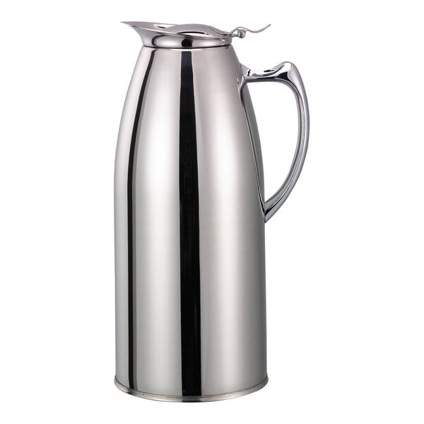 A chrome finish stainless steel pitcher with a lid and handle.