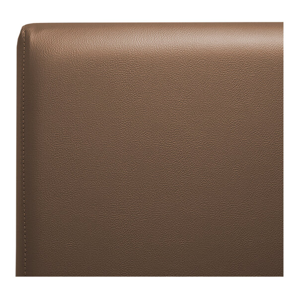 A brown leather surface on the back of a QA Group restaurant booth.