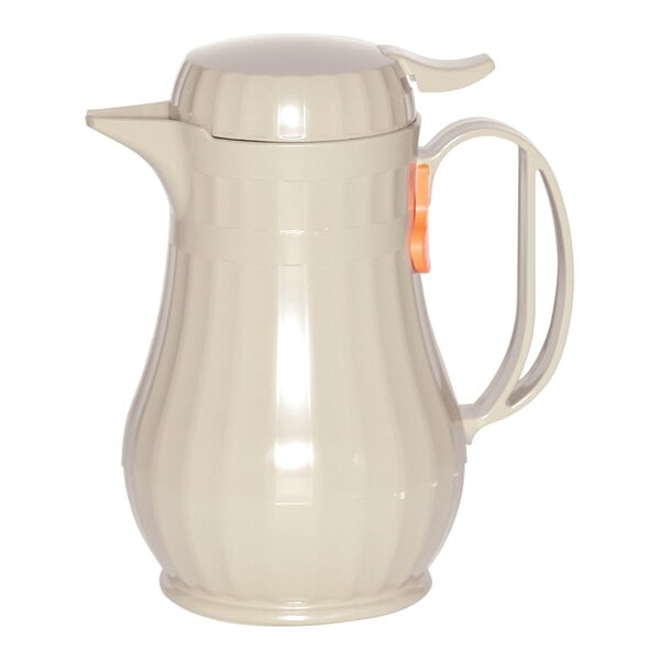 A beige plastic latte coffee carafe with a handle.