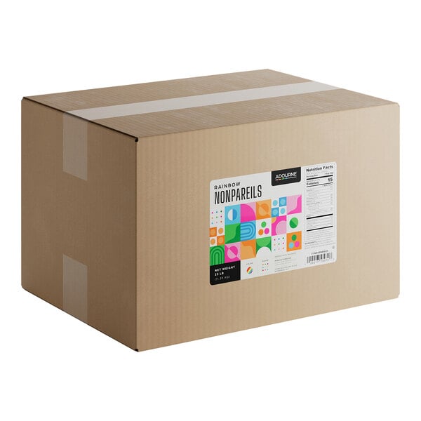 A large cardboard box labeled 'Adourne Rainbow Nonpareils' containing 25 pounds of nonpareil sprinkles.
