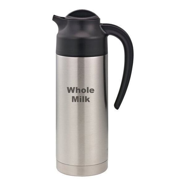 A stainless steel Service Ideas SteelVac creamer with "Whole Milk" written in black.